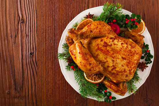 Roasted whole chicken with Christmas decoration.