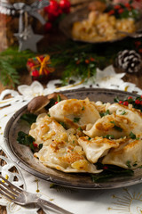 Traditional dumplings with cabbage and mushrooms. Christmas decoration.