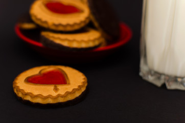 Cookies on a plate and a glass of milk