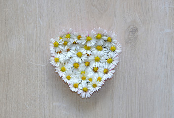 Obraz premium heart of flowers on wooden background, i love you, mothers day