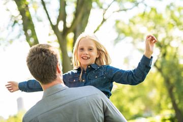 A father with daughter in summer park