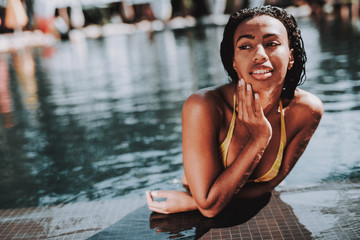 Portrait of Young Black Woman Relaxing in Pool
