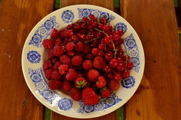 Малина, смородина и клубника на тарелке