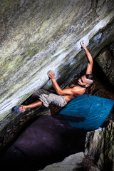 Strong boy climbing a stone