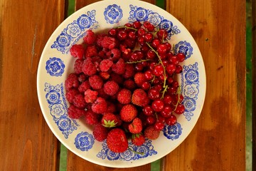 Малина, смородина и клубника на тарелке