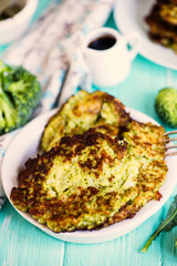 fried broccoli pancakes on a plate on a wooden board