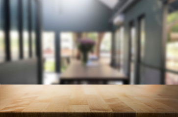 Selected focus empty brown wooden table and Coffee shop or restaurent blur background with bokeh image. for your photomontage or product display.