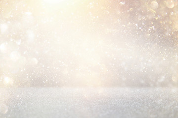 glitter vintage lights background. silver and gold. de-focused.