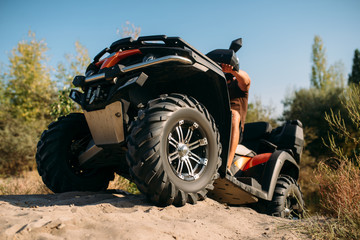 Atv rider climbing the sand mountain in quarry © Nomad_Soul