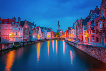Scenic city view of Bruges canal with beautiful medieval colored houses, bridge and reflections in the evening, Belgium