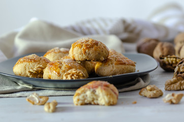 Shortcake of walnut on a wooden background.