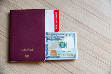 Thai passport, dollars banknote, airline ticket. time to travel and freedom concept.welcome to summer vacation seasons.business trip,trust to international immigration.