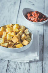 Portion of patatas bravas with sauces