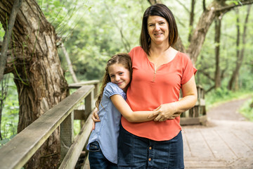 mother and her daughter on summer forest