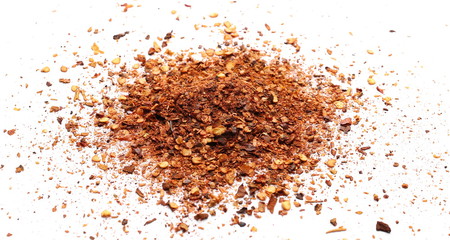 Crushed, ground red cayenne pepper, dried chili flakes and seeds isolated on white background