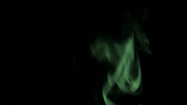 Green Steam Rises from up. Green smoke over a black background. Smoke slowly floating through space against black background. 4K UHD