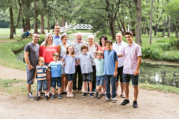 Large family with cousin grandparent father and kid on a forest