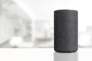 Personal assistant loudspeaker on a white wooden shelf of a smart home living room. Empty copy...