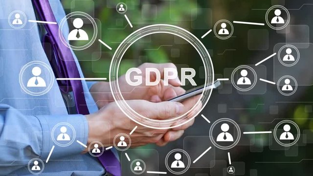 Businessman presses button GDPR general data protection regulation on phone and virtual electronic user interface.