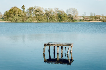 Naklejka premium Lonely bridge on the lake.