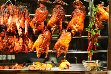 Hanged roasted ducks in a showcase on street food market in Singapore
