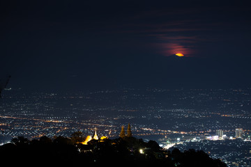 Naklejka premium Chiang Mai landscape and red full moon and clouds