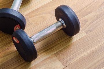 Dumbbells on wooden floor