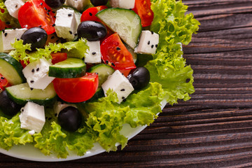 Greek salad on a wooden rustic background