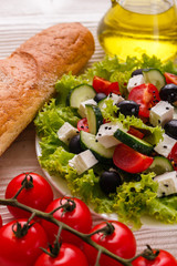 Greek salad on a wooden rustic background