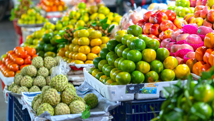 Fruit shops in the market with all kinds like: tangerines. pomegranate, orange, apple, pear, grape, mango, dragon fruit, lychee ... all Arranged on shelves look attractive and eye-catching.