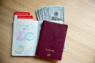 Thai passport, dollars banknote, airline ticket. time to travel and freedom concept.welcome to summer vacation seasons.business trip,trust to international immigration.