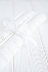 Two rolls of white fabric on a white background. Free space