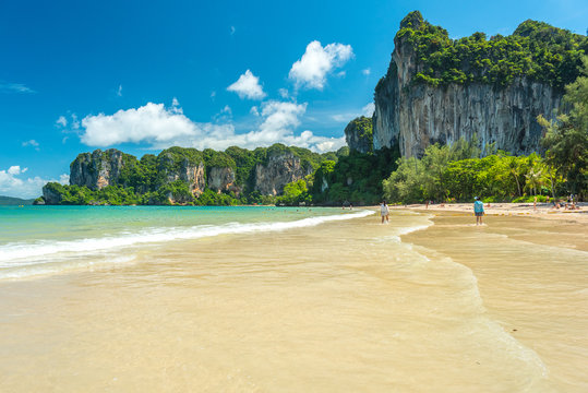 Railay Beach West. Cliffs covered with jungles and clear water during a beautiful sunny day in July (low season). Krabi, Thailand