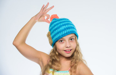 Knitted hat with pompon. Girl long hair happy face white background. Kid wear warm soft knitted...