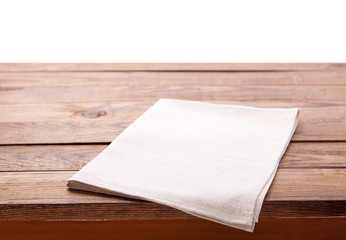 Kitchen towel on empty wooden table. Napkin close up top view mock up for design. Kitchen rustic background.