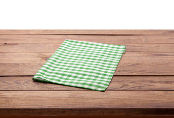 Kitchen towel on empty wooden table. Napkin close up top view mock up for design. Kitchen rustic background.