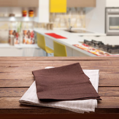 Kitchen towel on empty wooden table. Napkin close up top view mock up for design. Kitchen rustic background.