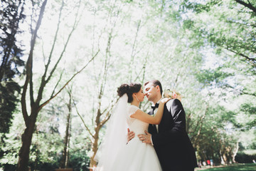 Kissing wedding couple in spring nature close-up portrait