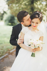 Kissing wedding couple in spring nature close-up portrait