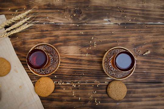 biscuits with two glasses of tea on wooden table as chat place