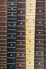 Six guitar necks aligned, Rosewood, maple and ebony fingerboard necks