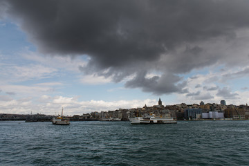Fototapeta premium ouristic boats in Golden Horn bay of Istanbul and view on Galata tower, Turkey