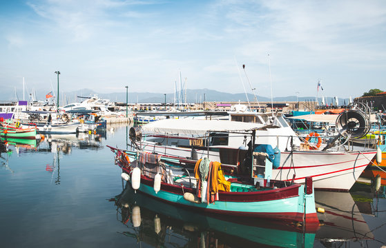 Old fishing boats are moored in port
