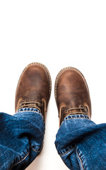 Men's brown boots and blue jeans isolated
