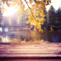 Naklejka na ściany i meble Empty table over blurred trees and river as background, product display template. Selective focus