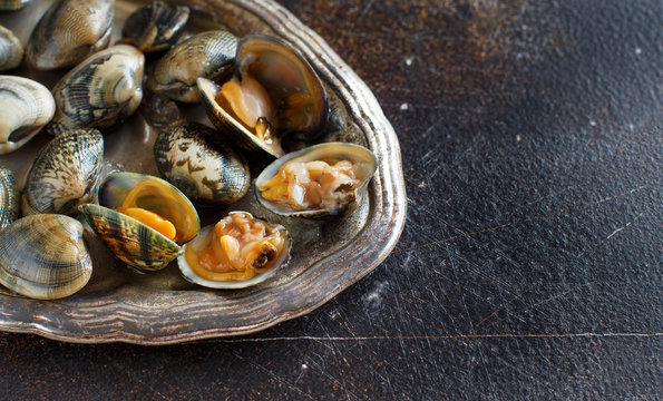 Metal tray with raw fresh vongole clams