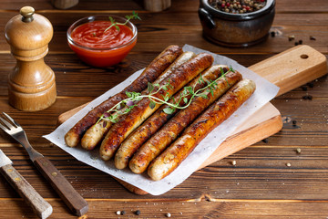 Pork chipolata. Close-up view of fried sausages. Meat dish