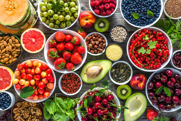 Selection of healthy food. Superfoods, various fruits and assorted berries, nuts and seeds.