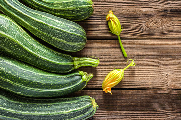 Fresh organic zucchini in wooden background, vegetable harvest