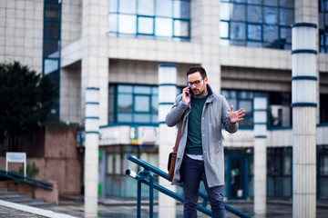 Unhappy businessman talking on the phone